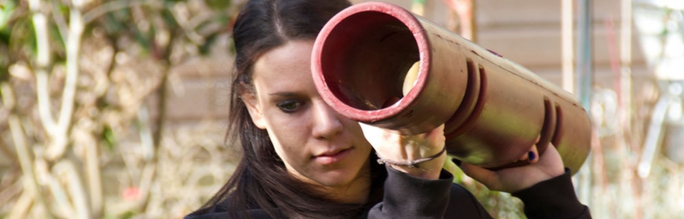 Gemma outdoors, holding a ViPR tube on her shoulder.